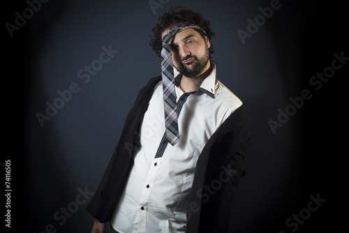 Young man drunk with necktie on head photo
