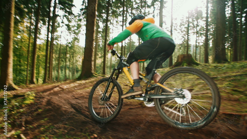 Mountain Biker Riding On Forest Trail in slow motion Mountain Biker Riding On Forest Trail in slow motion
