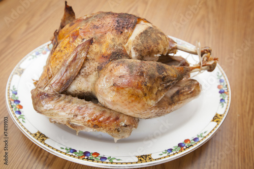 A cooked Thanksgiving Day turkey on a plate.