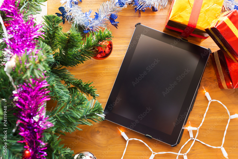 black tablet on table wood with christmas decoration