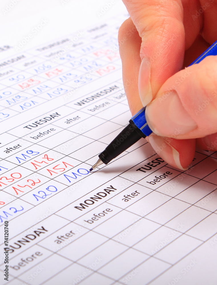 Hand of woman writing data to medical form Hand of woman writing data to medical form