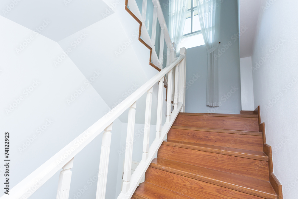 Obraz premium wooden staircase made from laminate wood in white modern house