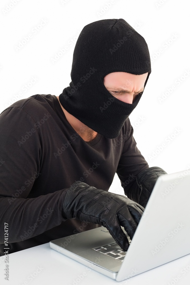 Hacker using laptop to steal identity Hacker using laptop to steal identity
