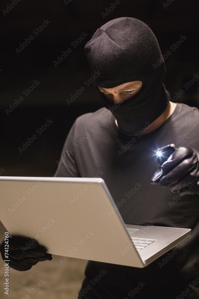Hacker using laptop to steal identity Hacker using laptop to steal identity
