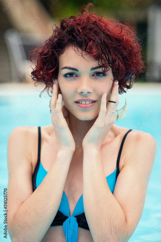Intimate portrait of beautiful redhead woman in swimming pool. Intimate portrait of beautiful redhead woman in swimming pool.