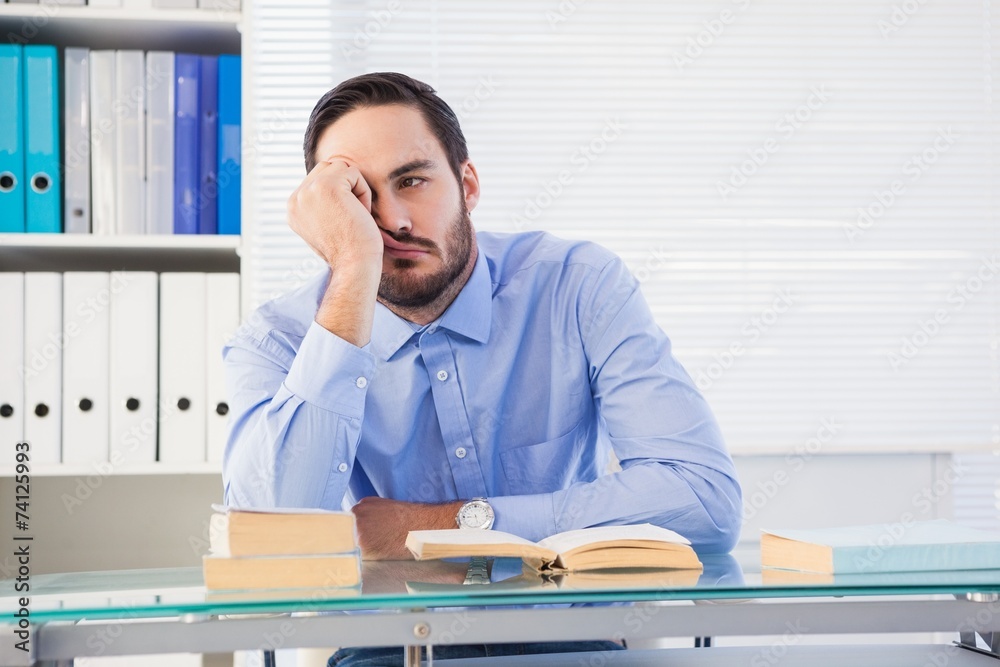 Casual bored businessman at his desk Casual bored businessman at his desk