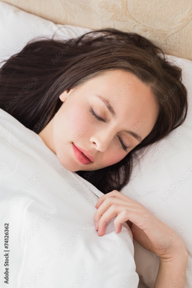 Pretty brunette under the duvet