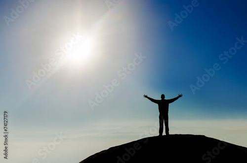 Silhouette of successful man on the top of the world