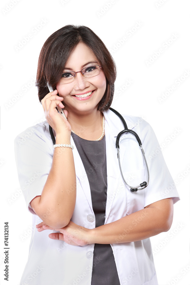 Attractive female doctor in lab coat with stethoscope talking wi Attractive female doctor in lab coat with stethoscope talking wi