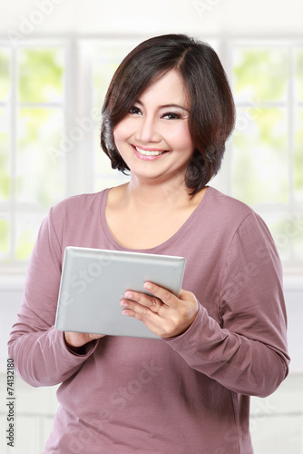 casual middle aged Woman holding tablet computer