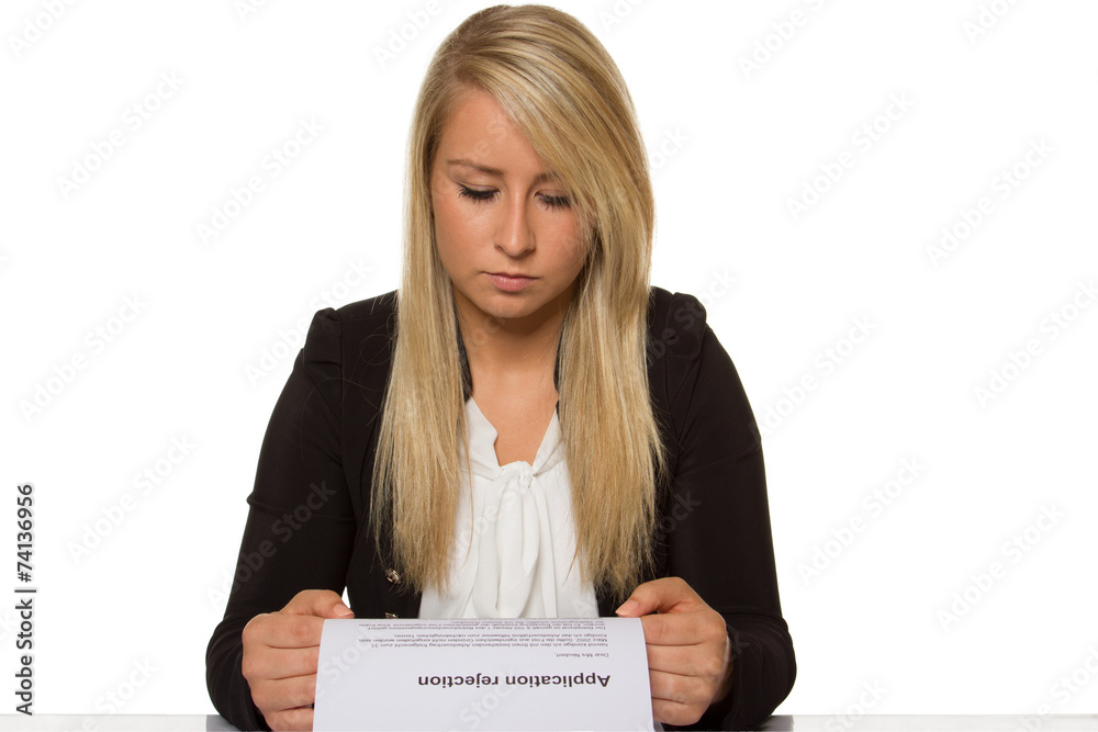 Young woman got a job application rejection a looks astonished Young woman got a job application rejection a looks astonished