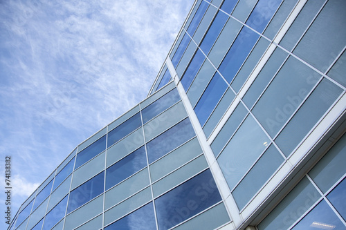 facade of glass and steel with reflections of blue sky