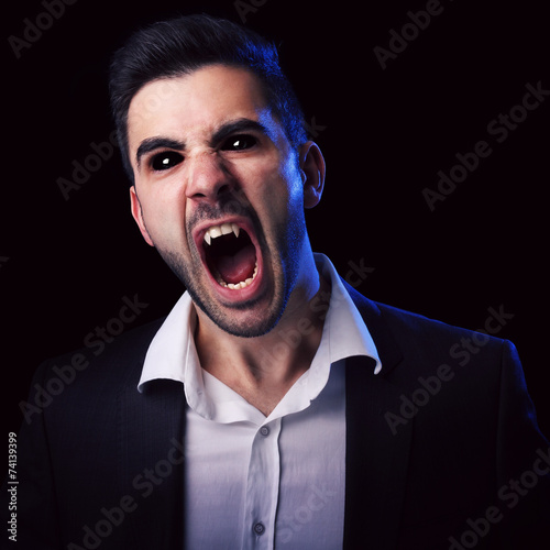 Scary man with black eyes and fangs