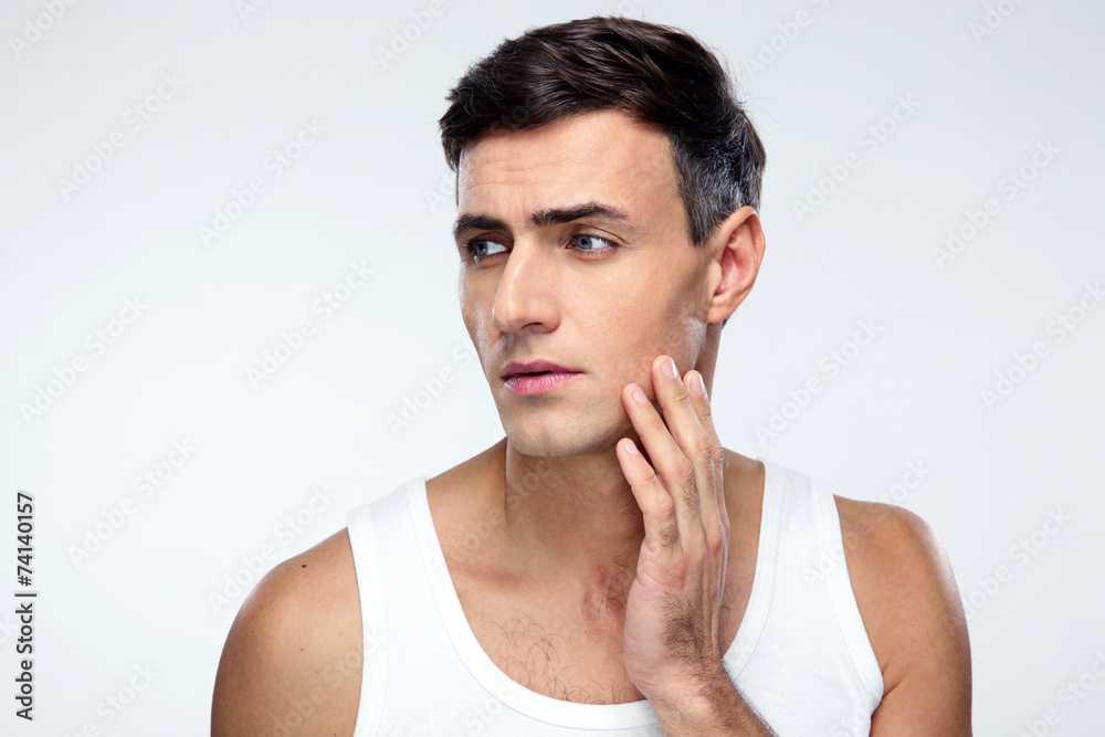 Pensive man looking away over gray background Pensive man looking away over gray background