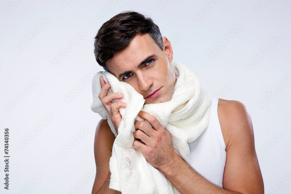 Portrait of a man drying his face with towel Portrait of a man drying his face with towel
