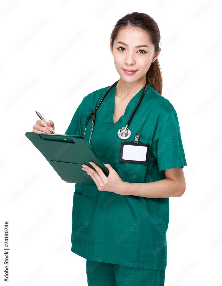 Asian Doctor take note on clipboard Asian Doctor take note on clipboard