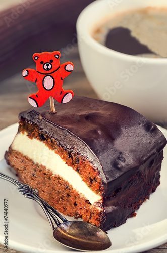 Carrot cake with coffee and teddy bear stick photo