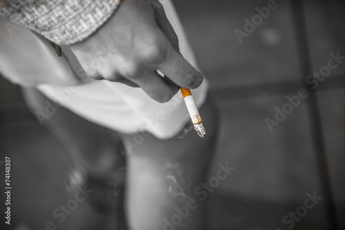 Cigarette in his hand to a woman
