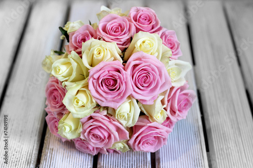 Wedding bouquet of fresh bridal flowers on white boards