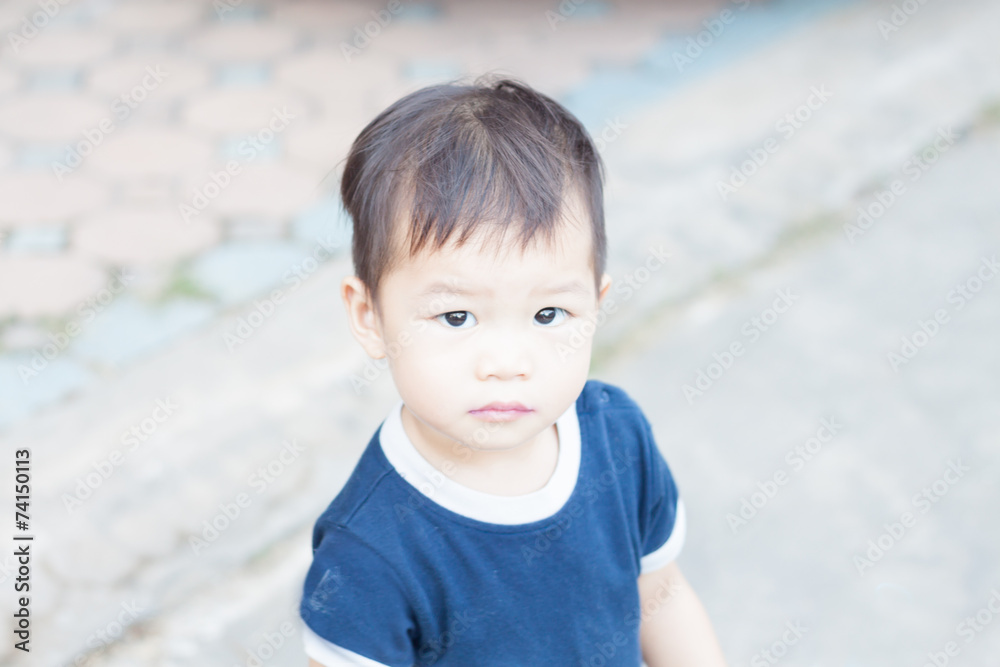 Little asian boy looking at camera