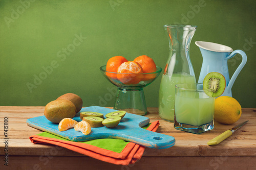 Healthy fruits and juice on wooden table