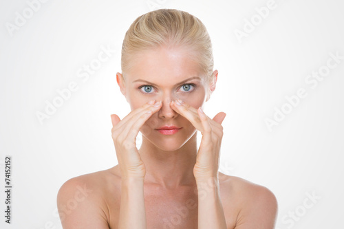 nordic beauty applying cream on her nose