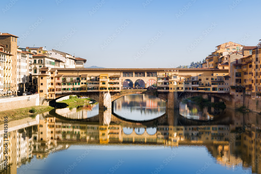 Antique bridge in Florence over Arno river with old houses
