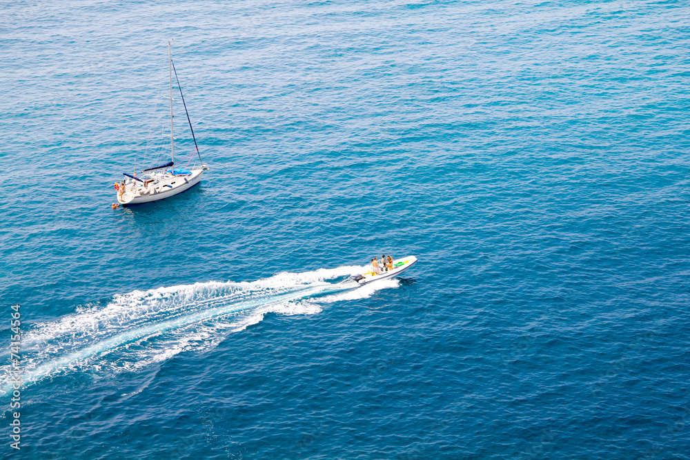 Obraz premium A Boat and a Yacht in the Mediterranean sea, Italy