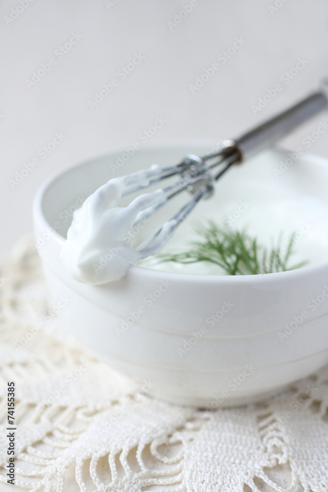 Fresh cream cheese spread in white bowl with dill and corolla Fresh cream cheese spread in white bowl with dill and corolla