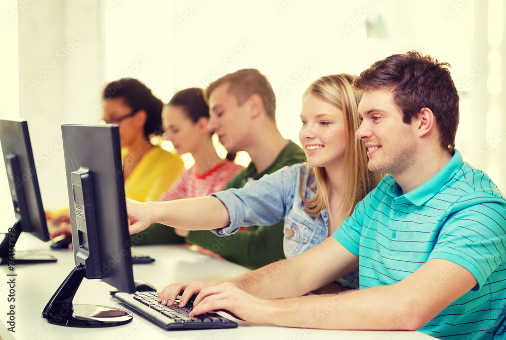 Fototapeta premium smiling students in computer class at school