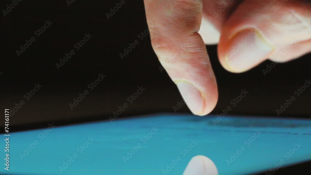Person using tablet computer at night Person using tablet computer at night