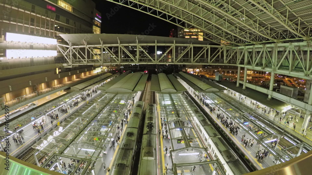 Timelapse video of trains and commuters in a railway station Timelapse video of trains and commuters in a railway station