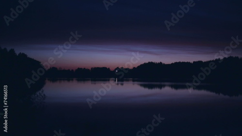 Lonely ascetic house on the lake at night photo