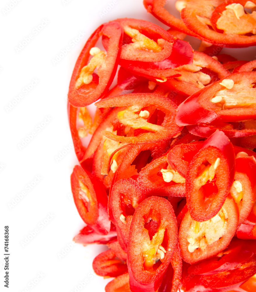 Cut slices of red chili pepper on white background