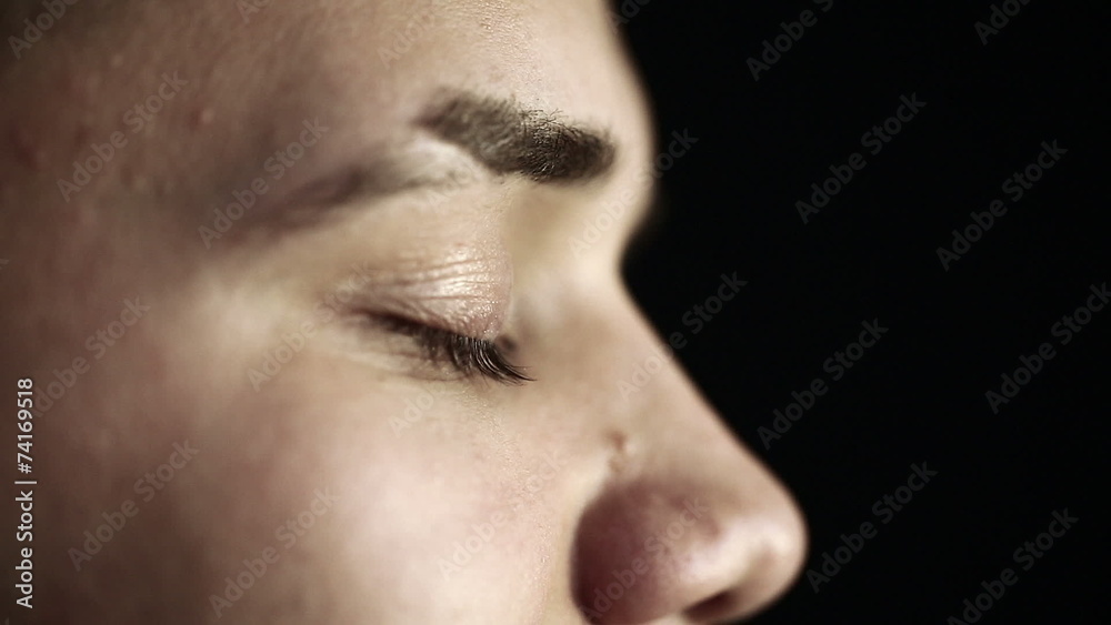 Close up profile face of a young man with green eyes. Close up profile face of a young man with green eyes.