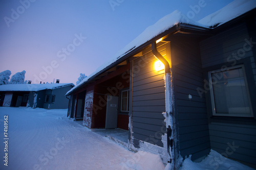 Beautiful lapland snowy winter landscape with cottage cabin vill