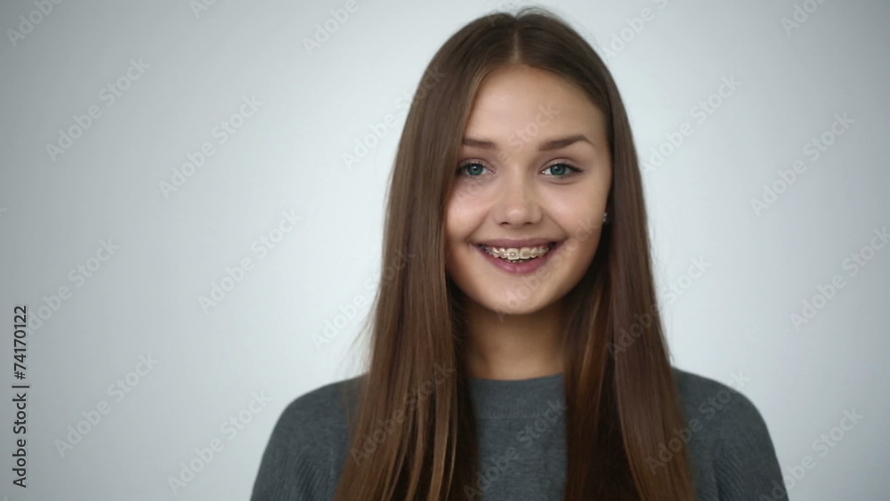 Young girl with braces on teeth looking at camera and smiling. Young girl with braces on teeth looking at camera and smiling.