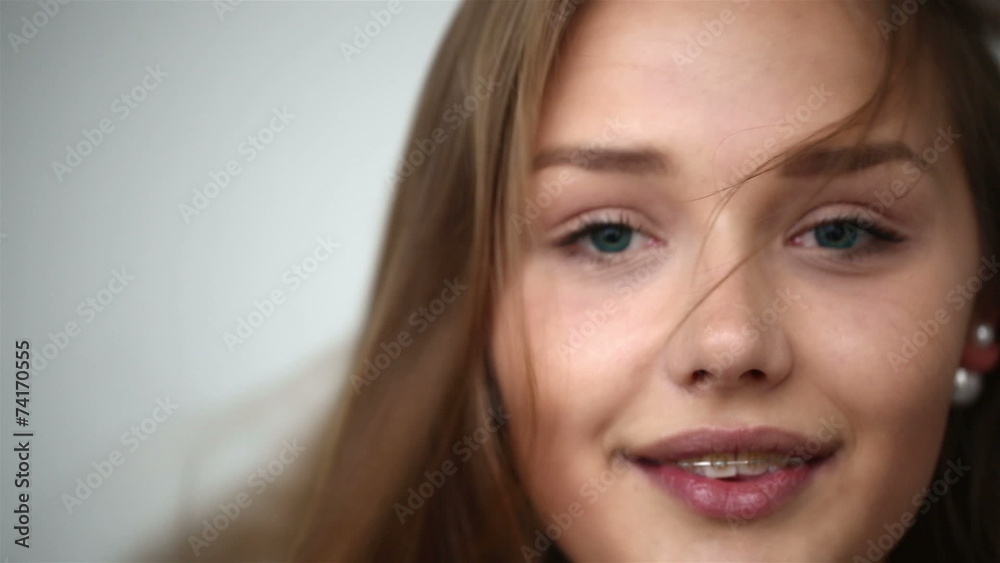 Young girl with braces on teeth throws back her head. Young girl with braces on teeth throws back her head.