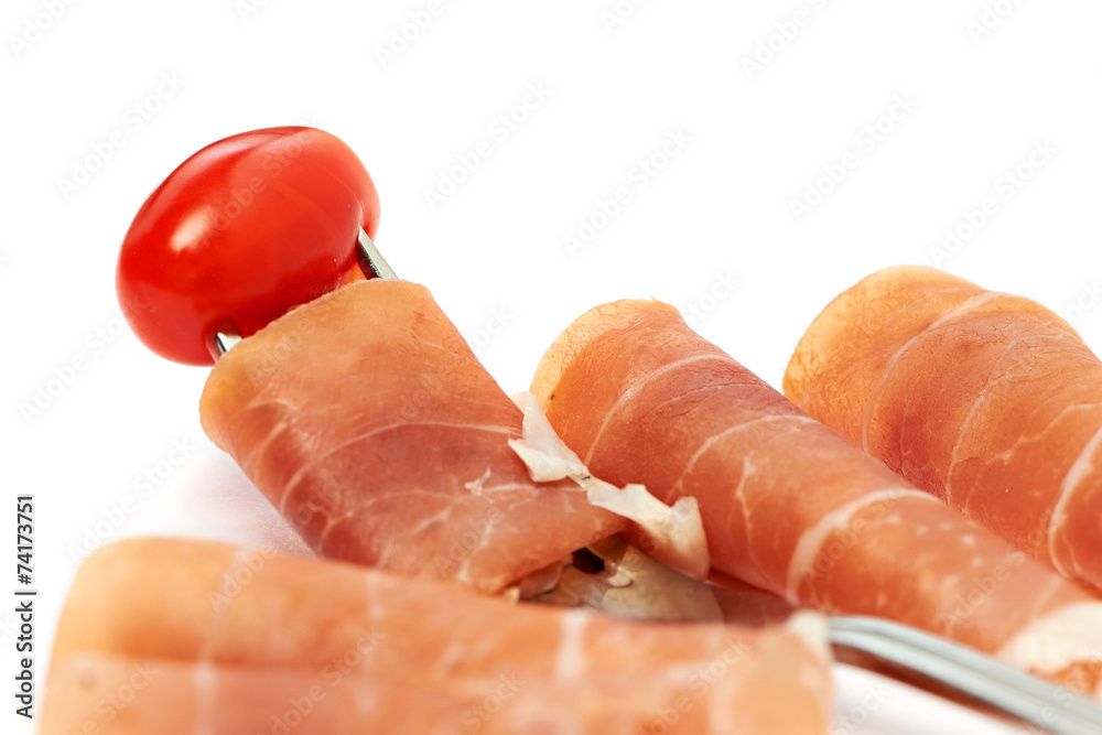 Ham on a fork and tomato