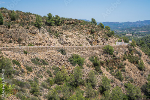 Side view of ascending mountain road with curves