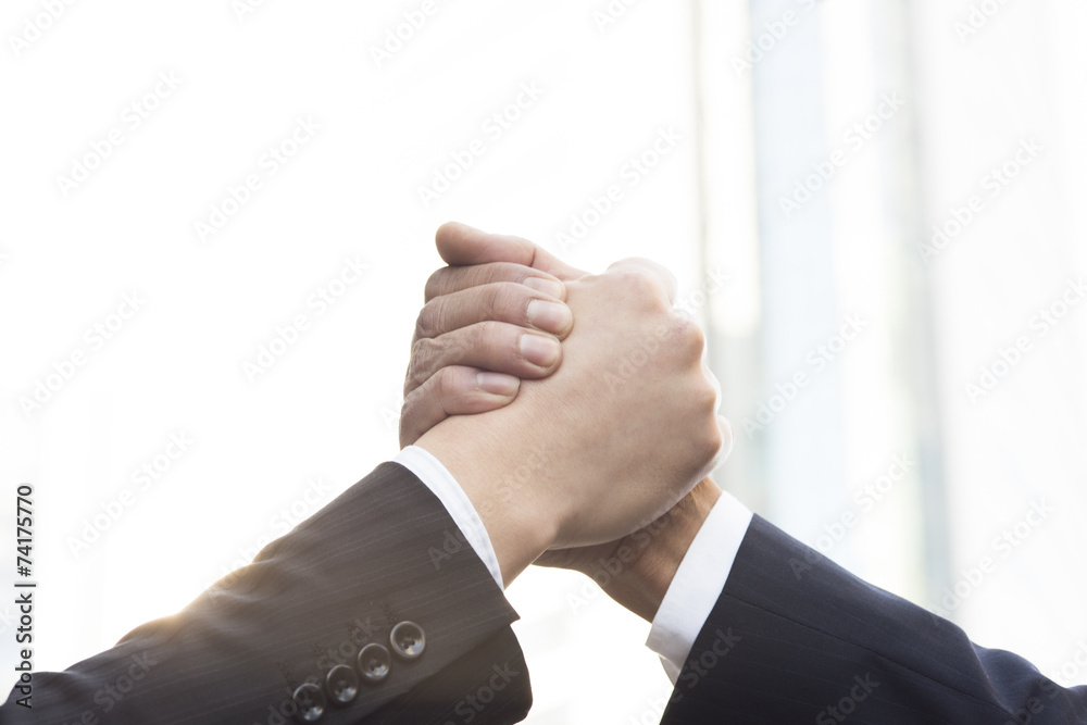 Fototapeta premium Businessmen join hands