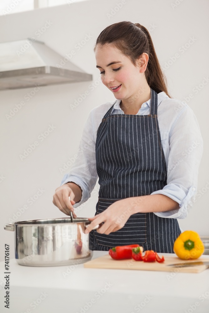 Pretty brunette cooking a healthy meal