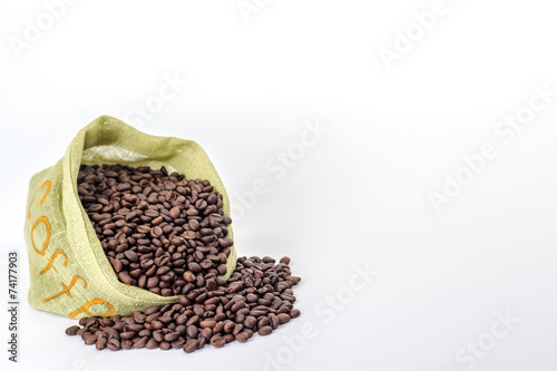 coffee beans spilled out of green bag