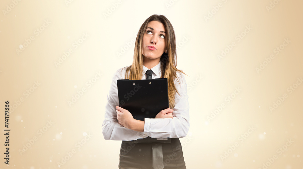 Cute businesswoman thinking an idea over isolated white backgrou Cute businesswoman thinking an idea over isolated white backgrou