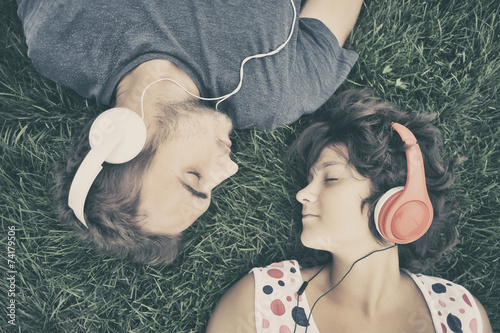 Couple listening to music on headphones
