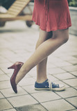 Woman legs in different shoes