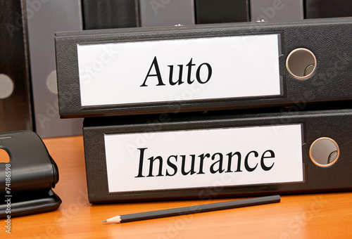 Auto Insurance - two binders on desk in the office