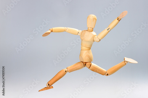Wooden mannequin jumping