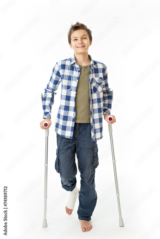 Teenage Boy with crutches and a bandage on his right leg Teenage Boy with crutches and a bandage on his right leg