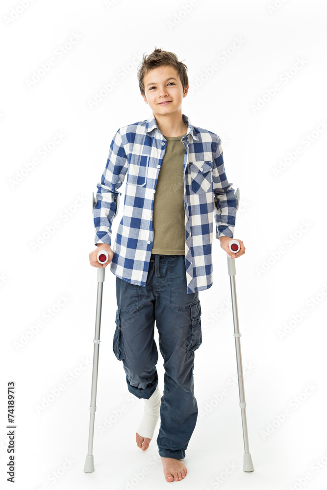 Teenage Boy with crutches and a bandage on his right leg Teenage Boy with crutches and a bandage on his right leg